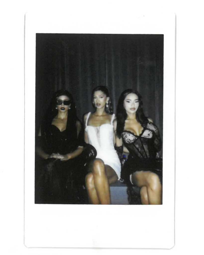 Nour, Manahil and Nee pose in black and white outfits